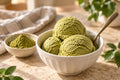 Matcha ice cream and matcha powder on a cream café counter